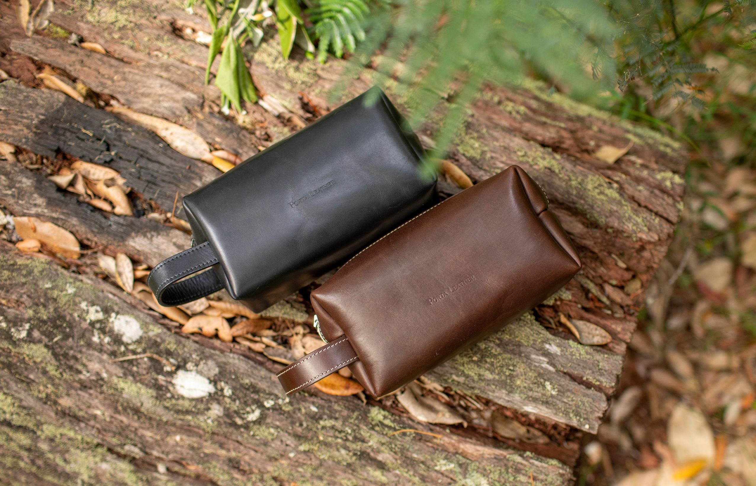 Porta Leather bovine dopp kit in black and brown on log 