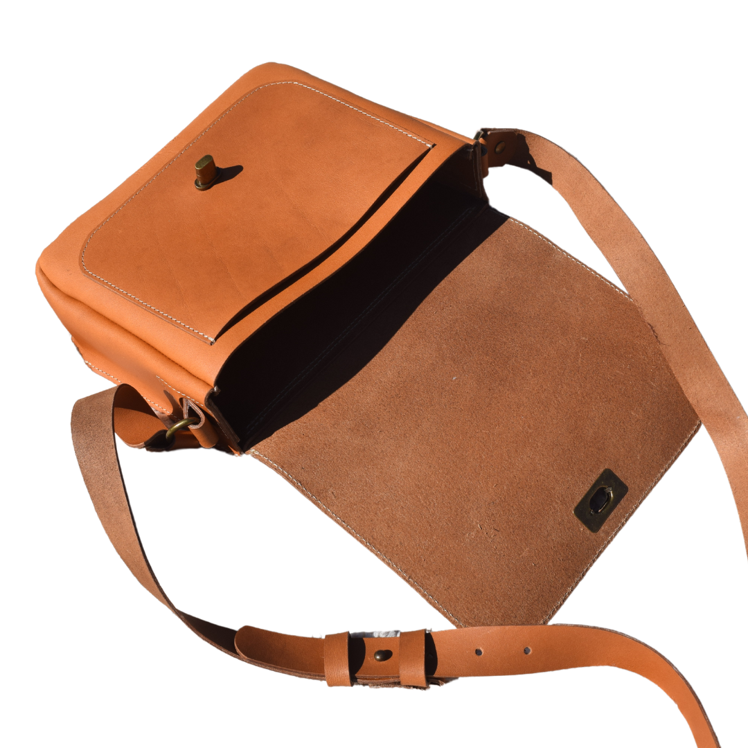 Open view of Porta Leather Dekota Saddle Bag in Heritage Tan with antique hardware