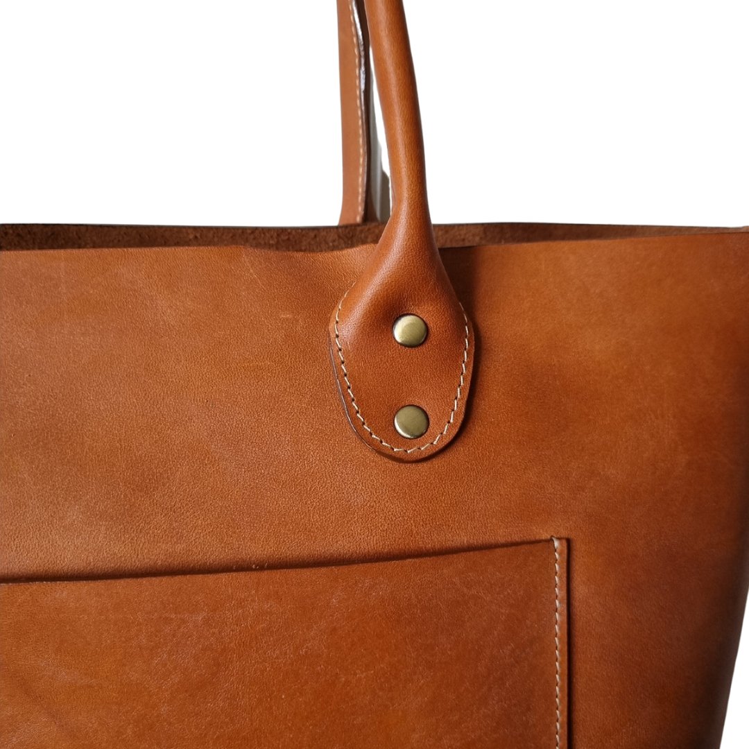 Front view of handcrafted Australian made Porta Leather Heritage Tote bag in whiskey and antique view of pocket and handle details