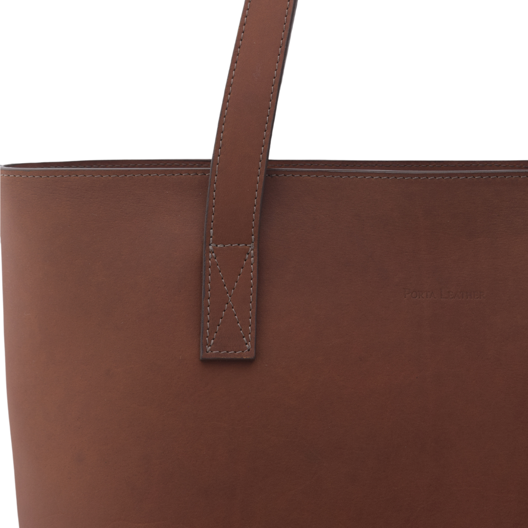 Close up of the handle on the Porta Leather Elena Tote Bag in Heritage Brown