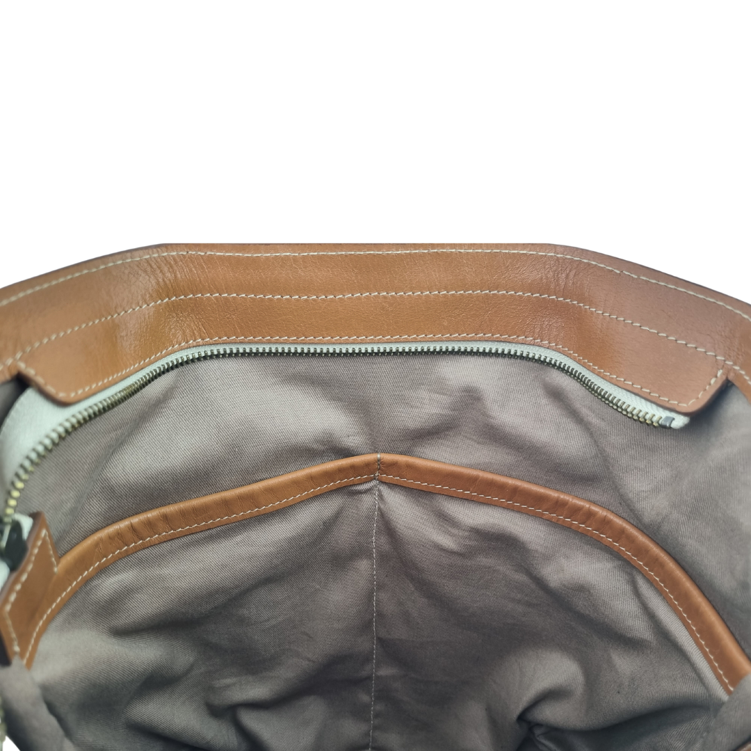 Internal view of the Porta Leather Essential Crossbody bag in tan showing the two large pockets 