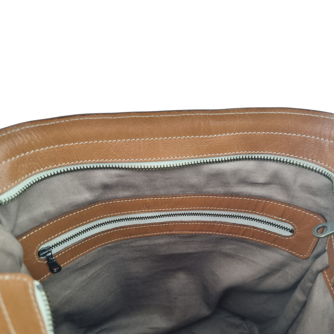 Internal view of Porta Leather Essential Crossbody bag in tan showing zipper compartment